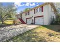The exterior of the home has a two-car garage and red staircase to front door at 945 Blackwell Rd, Marietta, GA 30066