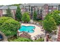 Aerial shot showcasing the community pool and lounge area in a red brick condo building at 1735 Peachtree Ne St # 316, Atlanta, GA 30309