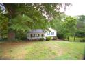 Charming home featuring a well-manicured lawn and beautiful landscaping, surrounded by lush greenery at 188 Thornbrooke Dr, Hiram, GA 30141