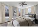 Serene bedroom with large windows, ceiling fan, neutral colors, and stylish bedding at 57 Forsyth Nw St # 6A, Atlanta, GA 30303