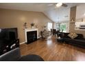 Open living room with fireplace, adjacent dining area, and hardwood floors at 2529 Feathertree Ln, Lawrenceville, GA 30044