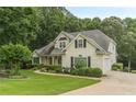 Beautiful home with a well-maintained lawn, mature trees, and an attached two-car garage at 9707 Squirrel Wood Run, Douglasville, GA 30135