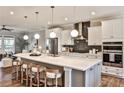 Bright, modern kitchen features a large island with seating, stainless steel appliances, and hardwood flooring at 1047 Brandsford Nw St, Atlanta, GA 30318