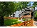 Inviting two-story home with a cozy front porch, beautiful lawn, and a newly installed stained fence at 1558 Line St, Decatur, GA 30032