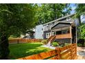 Beautifully landscaped front yard with a charming home, wooden fence and mature trees at 1558 Line St, Decatur, GA 30032