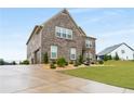 Beautiful brick home with a large driveway and well-maintained landscaping at 1604 Falcon Ct, Locust Grove, GA 30248