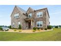 Lovely brick home with decorative landscaping and a spacious front yard at 1604 Falcon Ct, Locust Grove, GA 30248