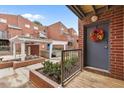 Exterior entrance with brick planters, white pergola, and a gray front door decorated with a wreath at 387 Ralph Mcgill Ne Blvd # K, Atlanta, GA 30312