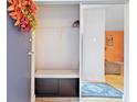 Entryway features closet with sliding doors and bench, hardwood flooring and an orange accent wall at 387 Ralph Mcgill Ne Blvd # K, Atlanta, GA 30312