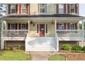 Inviting front porch featuring a swing, perfect for relaxing and enjoying the outdoors at 422 Inwood Trail Trl, Lawrenceville, GA 30043