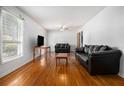 Spacious living room features hardwood floors and lots of natural light at 6085 Dunbritan Ln, Atlanta, GA 30349