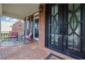Inviting front porch featuring rocking chairs and a stylish patterned rug at 6260 Sturbridge Ln, Cumming, GA 30040