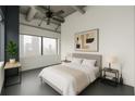 Bright bedroom features a large window overlooking the city, contemporary art, and a ceiling fan at 120 Ralph Mcgill Ne Blvd # 1502, Atlanta, GA 30308