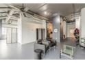 Spacious living room showcasing exposed pipes, gray walls, and an open kitchen area at 120 Ralph Mcgill Ne Blvd # 1502, Atlanta, GA 30308