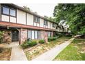 Charming townhome exterior with brick facade, lush greenery, and inviting entrance at 1200 Ashborough Se Ter # A, Marietta, GA 30067