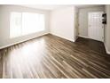 Bright living room featuring wood-look floors and a large window for natural light at 1200 Ashborough Se Ter # A, Marietta, GA 30067