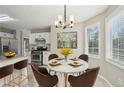 Charming dining area with modern chandelier and natural light from surrounding windows at 4005 Greentree Ct, Douglasville, GA 30135
