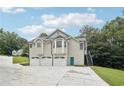 Exterior view of home with three car garage and second story entrance at 4005 Greentree Ct, Douglasville, GA 30135