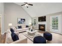 Living room featuring vaulted ceilings, wood floors, fireplace, and backyard access at 4005 Greentree Ct, Douglasville, GA 30135