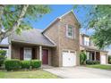 Brick home with attached one-car garage, attractive landscaping, and cozy curb appeal at 222 Ben Ln, Fairburn, GA 30213