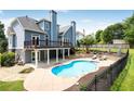 Stunning backyard showcases a private pool, deck, and well-maintained landscaping at 5513 Lavender Farms Rd, Powder Springs, GA 30127