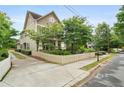 Beautiful house with a manicured lawn, complemented by lush trees and a charming white picket fence at 1184 Medlin Se St, Smyrna, GA 30080