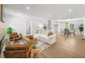 Spacious living room with hardwood floors, neutral decor, dining area and recessed lighting at 1366 Allegheny Sw St, Atlanta, GA 30310
