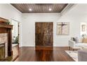 Grand foyer featuring hardwood floors, wood-paneled ceiling, and striking wooden double doors at 178 Mayson Ne Ave, Atlanta, GA 30307