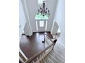 Grand foyer featuring a high ceiling, a chandelier, and a staircase with carpeted steps at 1991 Westover Nw Ln, Kennesaw, GA 30152