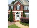 Close-up of arched entry door with sidelights flanked by manicured shrubbery at 1991 Westover Nw Ln, Kennesaw, GA 30152