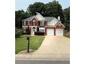 Charming brick two-story home with well-manicured lawn and two-car garage at 1991 Westover Nw Ln, Kennesaw, GA 30152