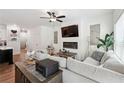 Open living area with a modern fireplace, lots of natural light, and ceiling fan at 2357 Heritage Park Nw Cir # 17, Kennesaw, GA 30144