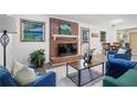 Cozy living room features a brick fireplace, plush seating, and hardwood floors at 5488 Janice Ln, Stone Mountain, GA 30087