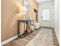 Warm entryway with wood floors, stylish console table, and decor for a welcoming ambiance at 1363 Cooper Springs Rd, Grayson, GA 30017