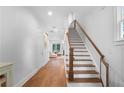 Bright foyer features hardwood floors, staircase with wood railing, and view into the living area at 1894 Dyer Cir, Atlanta, GA 30341