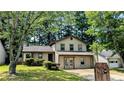 Two-story home with well-kept lawn and mature trees offering shade at 2015 Corners Cir, Lithonia, GA 30058
