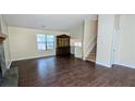Open living room area with hardwood floors, staircase, and natural light at 2015 Corners Cir, Lithonia, GA 30058