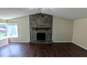 Spacious living room with hardwood floors and a stone fireplace at 2015 Corners Cir, Lithonia, GA 30058