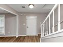 Inviting foyer featuring new laminate flooring and a staircase, enhancing the entrance appeal at 3130 Glen Knolls Ct, Alpharetta, GA 30022