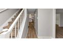 Hallway featuring new laminate flooring, leading to a kitchen with stainless steel appliances at 3130 Glen Knolls Ct, Alpharetta, GA 30022