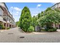 View of the townhome community featuring landscaped sidewalks and mature trees at 345 Glen Iris Ne Dr # 3, Atlanta, GA 30312