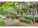 Charming townhomes with landscaped sidewalks, brick stairs, and a yellow front door at 345 Glen Iris Ne Dr # 3, Atlanta, GA 30312