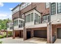 Townhome rear exterior featuring attached garages and Juliet balconies at 345 Glen Iris Ne Dr # 3, Atlanta, GA 30312
