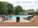 Relaxing community pool area with lounge chairs and tables, surrounded by lush greenery at 382 Winston Circle Cir, Canton, GA 30114