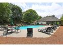 Community pool featuring plenty of chairs and tables, perfect for relaxation and recreation at 382 Winston Circle Cir, Canton, GA 30114