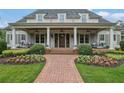 Inviting front porch with comfortable seating, ceiling fans, and a brick pathway leading to the entrance at 710 Cox Rd, Roswell, GA 30075