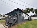 Side view of bungalow with newly stained gray porch and trimmed in blue at 8 Hazel St, Porterdale, GA 30014