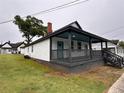 Bungalow exterior showcasing neat yard, gray-stained porch, and painted white siding at 8 Hazel St, Porterdale, GA 30014
