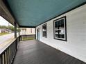 Spacious covered porch, perfect for relaxing with freshly stained wood at 8 Hazel St, Porterdale, GA 30014