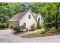 Beautiful home exterior showcasing a side view with a well-maintained lawn and lovely landscaping at 8255 Habersham Waters Rd, Atlanta, GA 30350